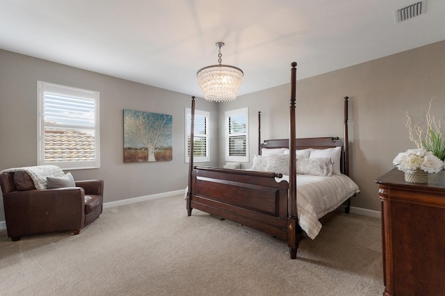 carpeted bedroom with a notable chandelier and multiple windows