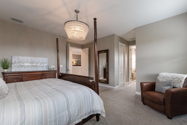 bedroom featuring light carpet, a notable chandelier, and ensuite bath