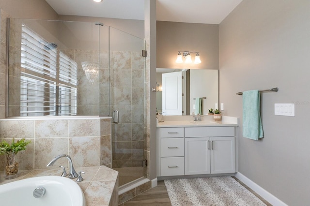 bathroom with vanity, plus walk in shower, and wood-type flooring