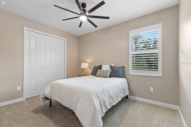 carpeted bedroom with a closet and ceiling fan