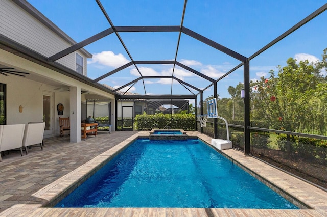 view of swimming pool featuring an in ground hot tub, ceiling fan, a lanai, and a patio area