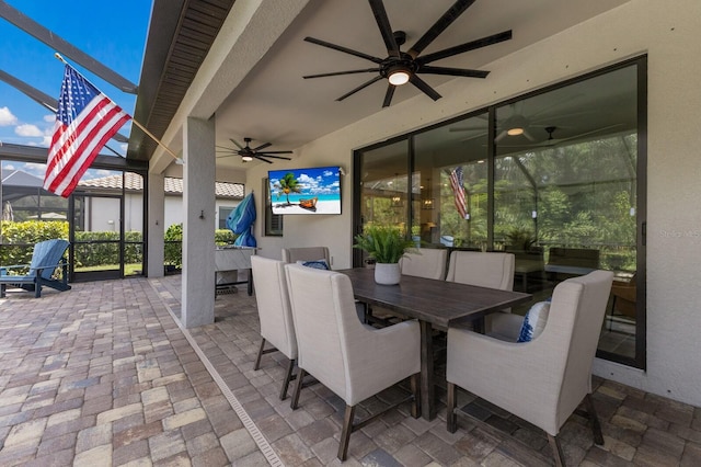 16215 Tradewind Ter, Lakewood Ranch, FL 34211 - view of patio / terrace featuring a ceiling fan, outdoor dining space, and glass enclosure