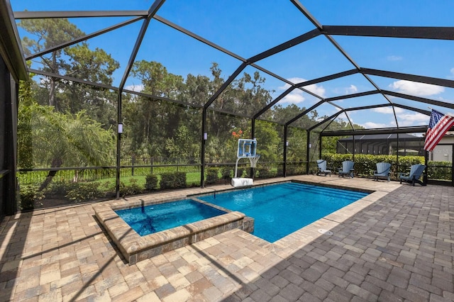 view of swimming pool featuring a patio, a lanai, and an in ground hot tub