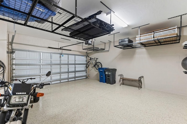 16215 Tradewind Ter, Lakewood Ranch, FL 34211 - garage featuring a garage door opener and concrete block wall