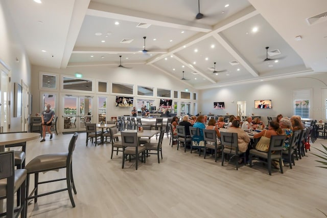 dining area with beamed ceiling, light hardwood / wood-style flooring, high vaulted ceiling, and ceiling fan