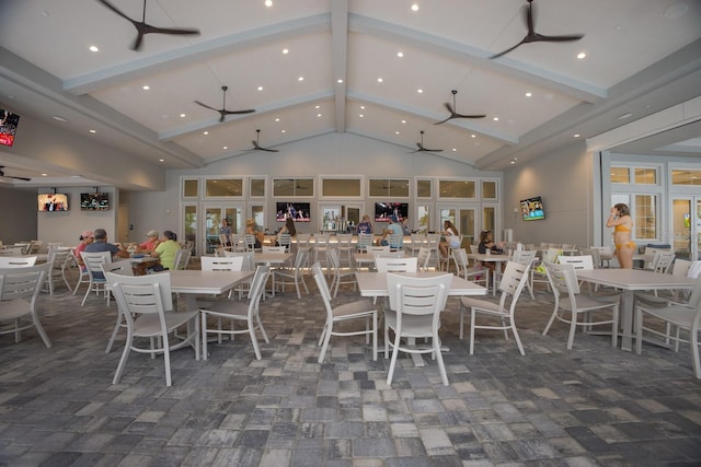 dining space featuring beamed ceiling, high vaulted ceiling, and ceiling fan