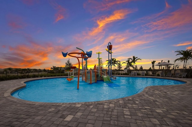 pool at dusk with a patio