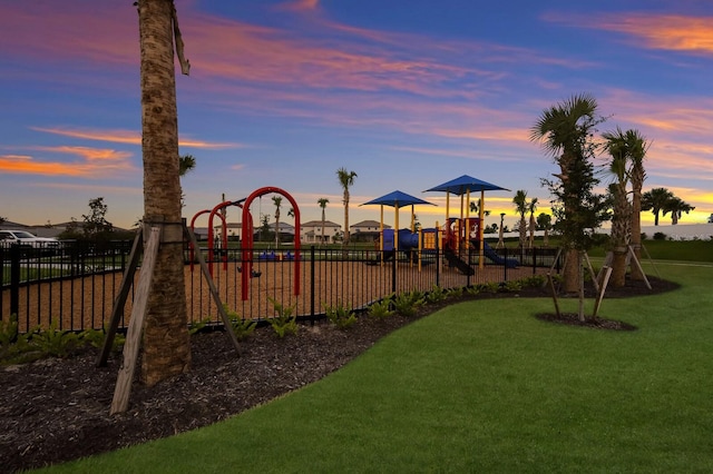 playground at dusk with a lawn