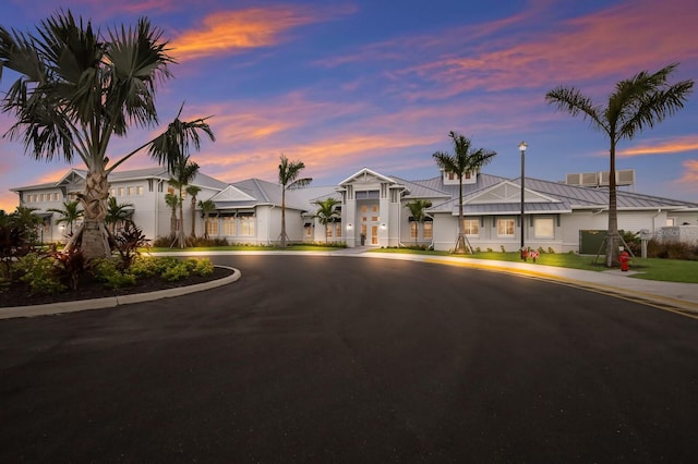 16215 Tradewind Ter, Lakewood Ranch, FL 34211 - view of front of property featuring a standing seam roof, curved driveway, and metal roof