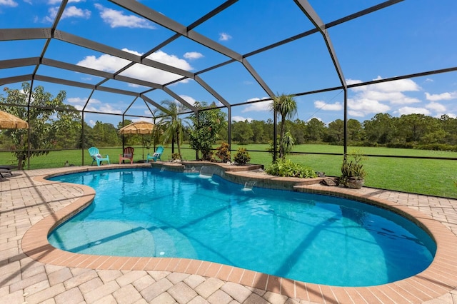 view of swimming pool featuring a lawn, a patio, and a lanai