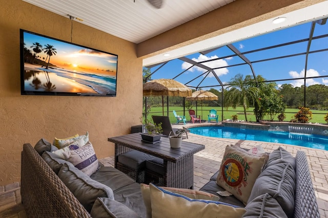 view of swimming pool featuring a patio, an outdoor living space, a lanai, a lawn, and pool water feature