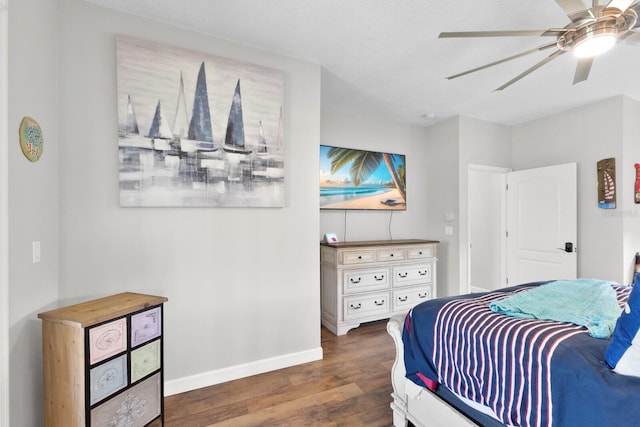 bedroom with ceiling fan and dark wood-type flooring