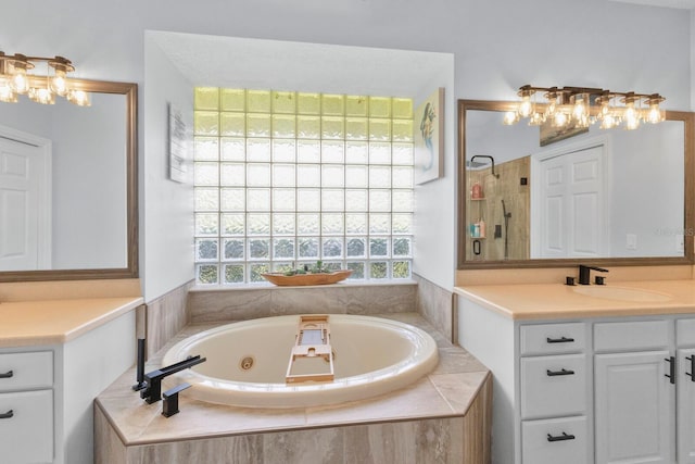 bathroom featuring vanity and separate shower and tub