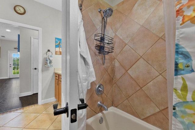 bathroom featuring vanity, hardwood / wood-style floors, and shower / bathtub combination with curtain