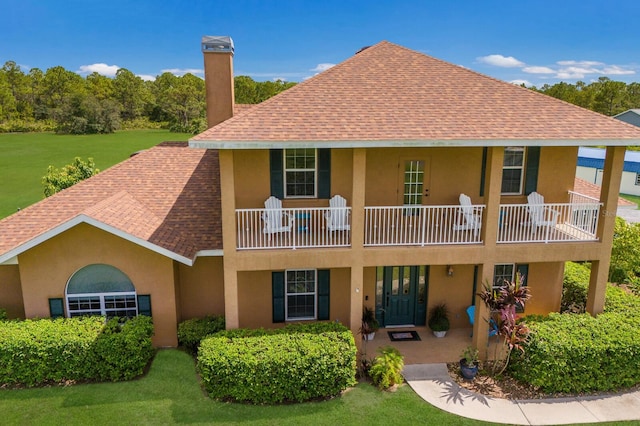 rear view of property with a lawn