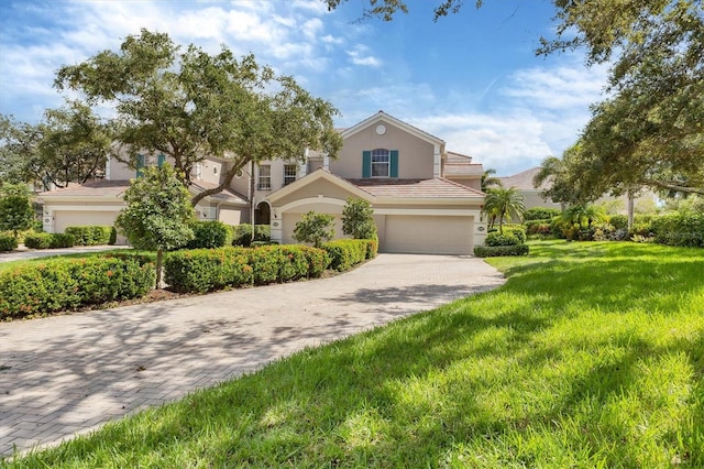 view of front of property featuring a front yard and a garage