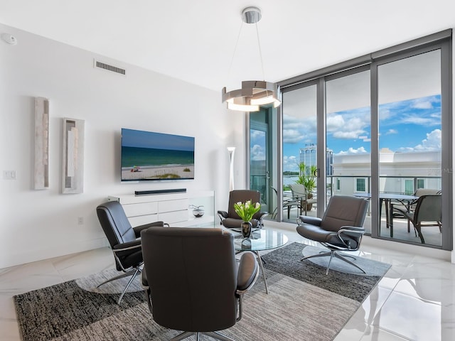 living room with baseboards, expansive windows, and visible vents