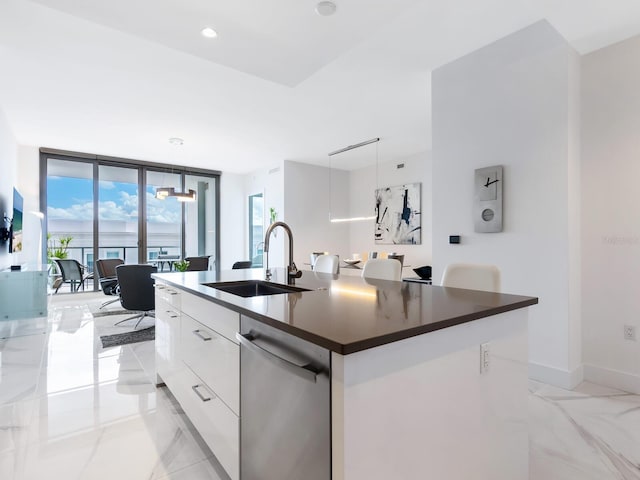 kitchen with dark countertops, white cabinetry, a sink, modern cabinets, and dishwasher