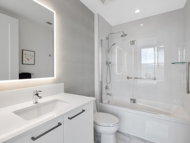 bathroom featuring enclosed tub / shower combo, visible vents, vanity, and toilet