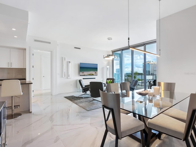 dining area with expansive windows, marble finish floor, visible vents, and recessed lighting