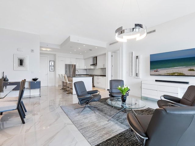 living area with recessed lighting, marble finish floor, and visible vents