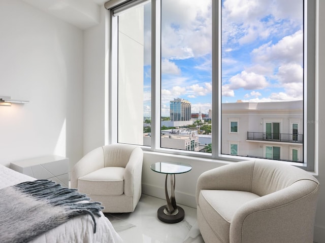 bedroom featuring a view of city and baseboards