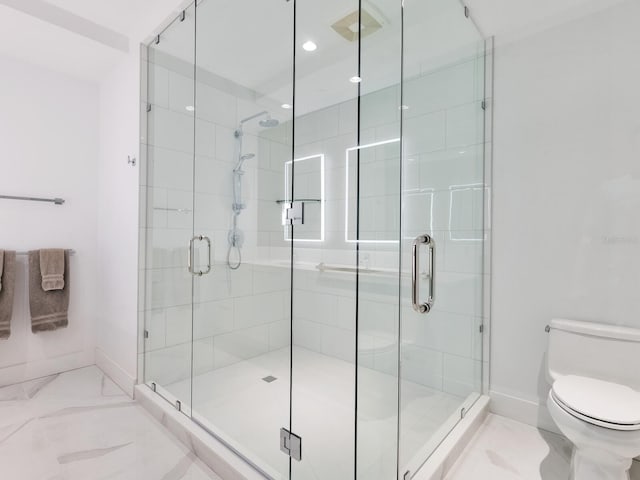 bathroom featuring toilet, recessed lighting, baseboards, marble finish floor, and a shower stall