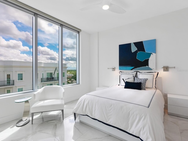 bedroom featuring marble finish floor, baseboards, and a ceiling fan