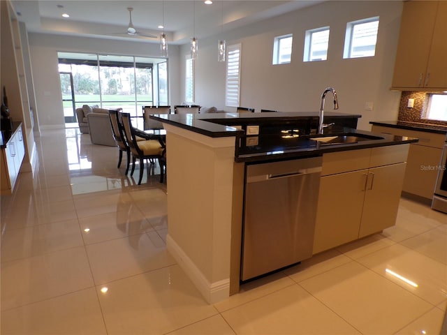 kitchen featuring a kitchen island with sink, stainless steel dishwasher, sink, and light tile patterned floors