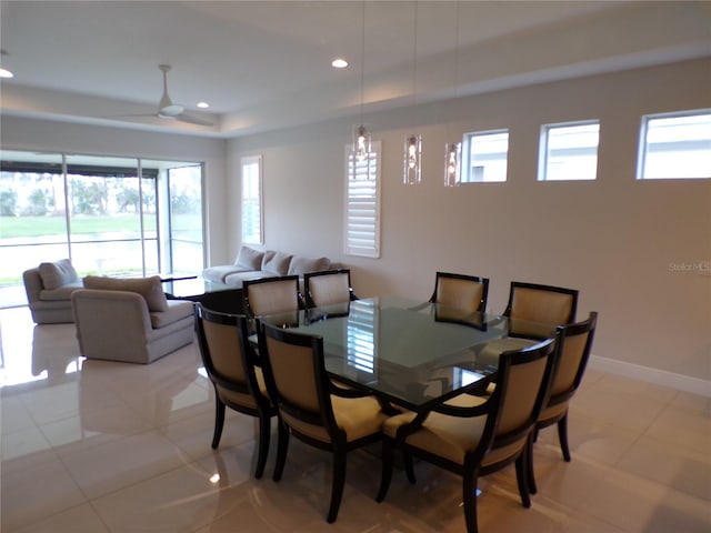 tiled dining space featuring ceiling fan