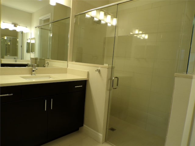 bathroom with vanity, tile patterned flooring, and a shower with door