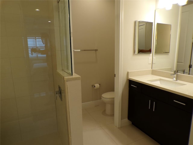 bathroom featuring a shower with door, toilet, tile patterned flooring, and vanity