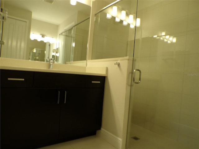 bathroom featuring vanity and an enclosed shower