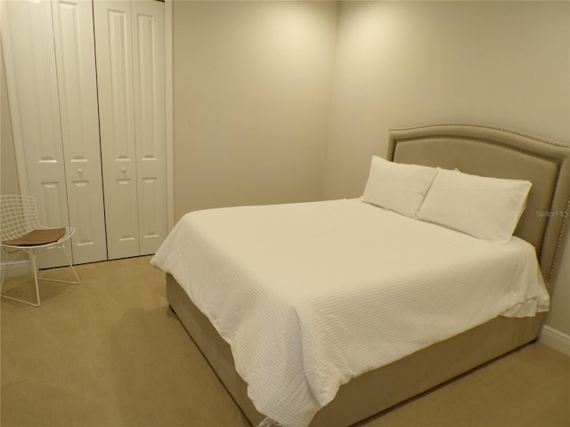 carpeted bedroom featuring a closet