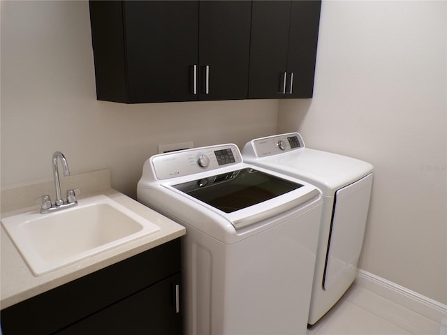 clothes washing area featuring sink, independent washer and dryer, light tile patterned floors, and cabinets