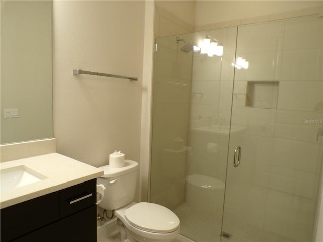 bathroom with vanity, toilet, and walk in shower