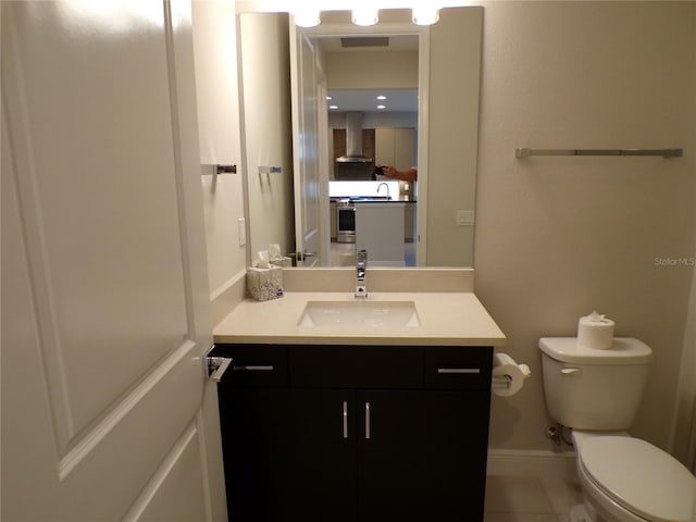 bathroom featuring vanity, toilet, and tile patterned floors