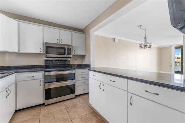 kitchen with white cabinetry, crown molding, appliances with stainless steel finishes, and a textured ceiling