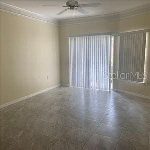 empty room with ornamental molding and ceiling fan