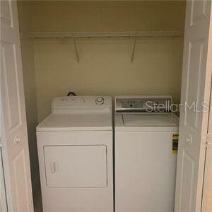 washroom with washing machine and dryer