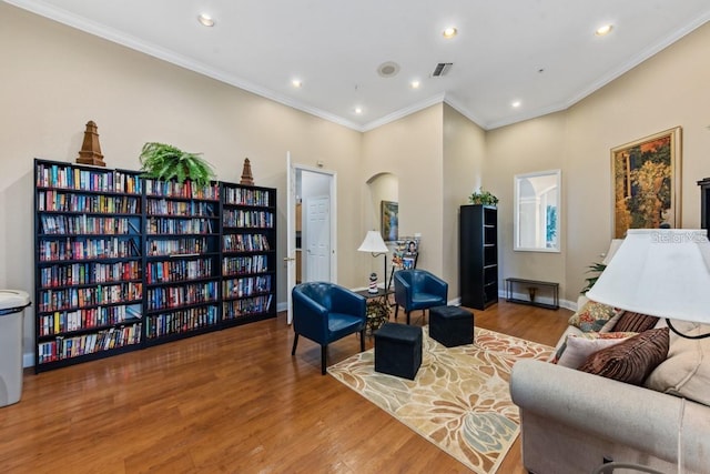 living room featuring crown molding and hardwood / wood-style flooring