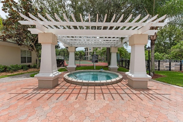 view of patio with a pergola and an in ground hot tub