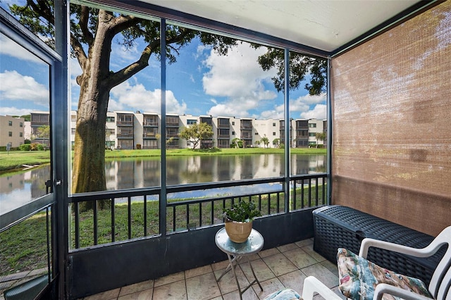 sunroom / solarium featuring a water view