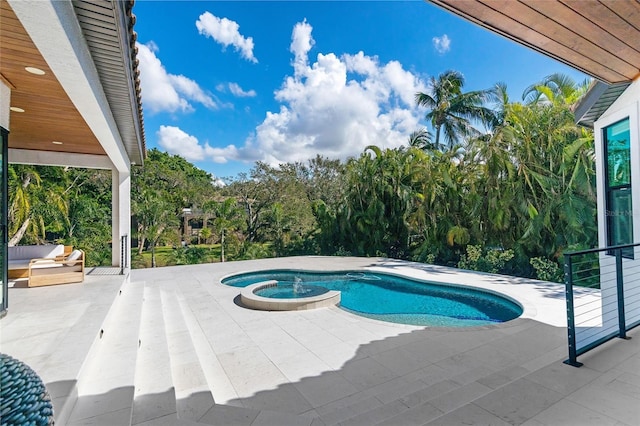 view of swimming pool featuring an in ground hot tub and a patio area