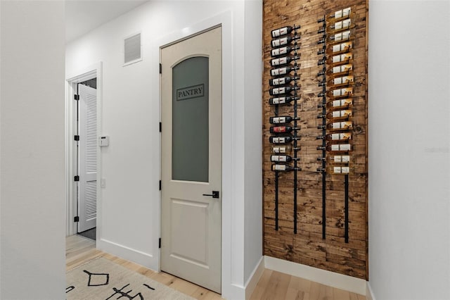 wine cellar featuring light hardwood / wood-style floors