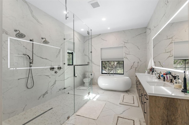 full bathroom featuring shower with separate bathtub, vanity, and toilet