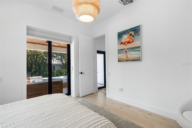 bedroom featuring light hardwood / wood-style floors and access to exterior