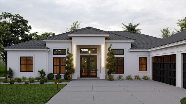 view of front of house with a garage and a front lawn