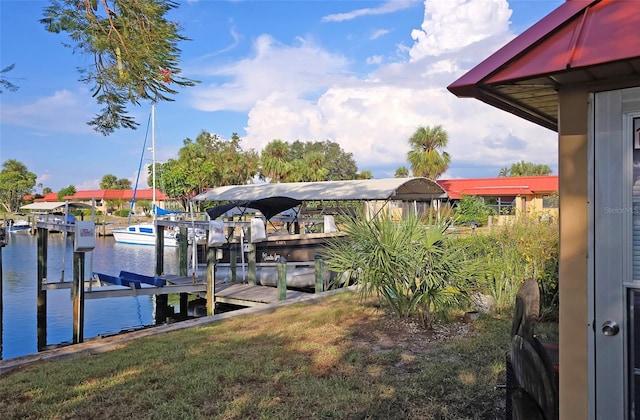 view of dock featuring a yard and a water view