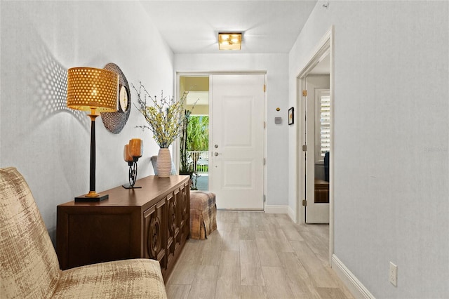 corridor featuring a wealth of natural light and light hardwood / wood-style flooring